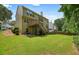 Spacious backyard with a well-maintained lawn and back view of the house at 1680 Laleiah Dr, Cumming, GA 30041