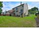 A spacious backyard with a well-maintained lawn and back view of the house at 1680 Laleiah Dr, Cumming, GA 30041