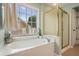 Bathroom with a soaking tub and shower with gold trim at 1680 Laleiah Dr, Cumming, GA 30041