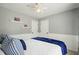 Bedroom with gray walls, and a bed with blue decorative pillows at 1680 Laleiah Dr, Cumming, GA 30041