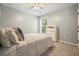 Bedroom featuring a patterned bedspread, neutral walls, and carpet flooring at 1680 Laleiah Dr, Cumming, GA 30041
