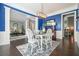 Stylish dining room with blue walls, white trim, and an open view to the living area at 1680 Laleiah Dr, Cumming, GA 30041