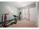 Home exercise room with carpet, and a variety of workout equipment and whiteboard at 1680 Laleiah Dr, Cumming, GA 30041