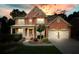 Stunning two-story brick home with a two-car garage and well-manicured landscaping at 1680 Laleiah Dr, Cumming, GA 30041
