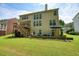 Exterior view of the home featuring a lush lawn and a relaxing patio area at 1680 Laleiah Dr, Cumming, GA 30041