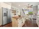 Charming eat-in kitchen with wood floors, stainless appliances, and custom island at 1680 Laleiah Dr, Cumming, GA 30041