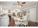 Open kitchen with stainless appliances, kitchen table, and dark hardwood floors at 1680 Laleiah Dr, Cumming, GA 30041