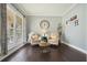 Cozy living room with hardwood floors, accent chairs, and a large window at 1680 Laleiah Dr, Cumming, GA 30041