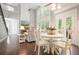 Sunlit living room with stone fireplace, hardwood floors, and soaring ceilings at 1680 Laleiah Dr, Cumming, GA 30041