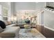 Open concept living room leading to kitchen with hardwood floors and large windows at 1680 Laleiah Dr, Cumming, GA 30041
