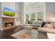 Bright living room with stone fireplace and large windows for natural light at 1680 Laleiah Dr, Cumming, GA 30041