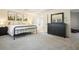 Bright bedroom features a black bed frame, black dresser, and artwork at 1680 Laleiah Dr, Cumming, GA 30041
