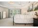 Spacious bedroom with trey ceilings, large window, and neutral colors at 1680 Laleiah Dr, Cumming, GA 30041
