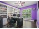 Bright home office with built-in shelving, desk, and hardwood floors at 1680 Laleiah Dr, Cumming, GA 30041