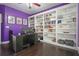 Large office with hardwood floors, desk, and large white built-in shelving at 1680 Laleiah Dr, Cumming, GA 30041