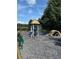 Community playground with a variety of play structures and soft padded ground cover at 1680 Laleiah Dr, Cumming, GA 30041