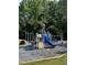 A community playground features multiple slides, climbing structures, and safe, padded ground cover at 1680 Laleiah Dr, Cumming, GA 30041