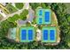 Aerial view of tennis and basketball courts surrounded by lush greenery in a community setting at 1680 Laleiah Dr, Cumming, GA 30041