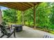 Covered patio area perfect for outdoor living, complete with an outdoor fireplace and seating at 309 Mcdaniel Pl, Canton, GA 30115