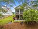 Backyard view of this home with a screened in back porch on the upper level and patio below at 309 Mcdaniel Pl, Canton, GA 30115