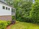 Beautiful backyard featuring a screened porch, lush lawn, and mature trees for privacy at 309 Mcdaniel Pl, Canton, GA 30115