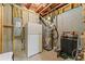 Unfinished basement area showcasing electrical and plumbing, offering ample storage space and customization at 309 Mcdaniel Pl, Canton, GA 30115