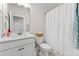 Clean bathroom featuring a white vanity, toilet, and a shower with a white curtain, creating a fresh and simple look at 309 Mcdaniel Pl, Canton, GA 30115