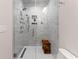 Modern bathroom with glass-enclosed shower featuring tile walls, a rain shower head, and a wooden bench at 309 Mcdaniel Pl, Canton, GA 30115