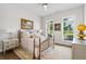 Cozy bedroom showcasing natural light, decorative light fixtures, and hardwood flooring at 309 Mcdaniel Pl, Canton, GA 30115