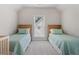 Bright bedroom featuring twin beds with light green bedding and natural light from window with blinds at 309 Mcdaniel Pl, Canton, GA 30115