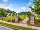 Inviting neighborhood entrance with brick pillars and well-manicured landscaping at 309 Mcdaniel Pl, Canton, GA 30115