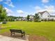 Beautiful lawn space with park bench and view of multiple two-story homes at 309 Mcdaniel Pl, Canton, GA 30115