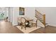 Dining area with wooden staircase and a comfortable seating area with a round table at 309 Mcdaniel Pl, Canton, GA 30115