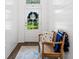 Bright entryway featuring a bench, rug and shiplap walls with natural light shining through at 309 Mcdaniel Pl, Canton, GA 30115