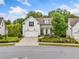 Charming two-story home with manicured lawn, pretty landscaping, and rocking chairs on the porch at 309 Mcdaniel Pl, Canton, GA 30115