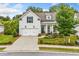 Charming home with a landscaped front yard, two-car garage, and inviting front porch with rocking chairs at 309 Mcdaniel Pl, Canton, GA 30115