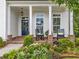 Inviting front porch features brick accents, rocking chairs, and lush landscaping at 309 Mcdaniel Pl, Canton, GA 30115