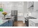 Well-equipped kitchen with stainless appliances, white cabinets, and a stylish island with a farmhouse sink at 309 Mcdaniel Pl, Canton, GA 30115