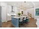 Stylish kitchen with stainless appliances, center island with seating, and adjacent staircase at 309 Mcdaniel Pl, Canton, GA 30115