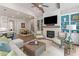 Spacious living room featuring a fireplace, built-in shelving, and an open layout to dining area at 309 Mcdaniel Pl, Canton, GA 30115