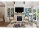Beautiful living room with fireplace, built-in shelving, and large windows allowing for natural light at 309 Mcdaniel Pl, Canton, GA 30115