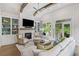 Comfortable living room featuring a fireplace, built-in shelving, a ceiling fan, and access to back porch at 309 Mcdaniel Pl, Canton, GA 30115