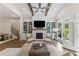 Comfortable living room with fireplace, stylish seating, and views to the outdoor balcony at 309 Mcdaniel Pl, Canton, GA 30115