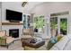 Bright and airy living room boasts a fireplace, built-ins, and access to screened porch at 309 Mcdaniel Pl, Canton, GA 30115