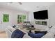 Bright living room with modern fireplace, TV, comfortable seating, and outdoor view from a glass door at 309 Mcdaniel Pl, Canton, GA 30115