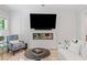 Inviting living room with modern fireplace, TV, comfortable seating, and a round coffee table on soft rug at 309 Mcdaniel Pl, Canton, GA 30115