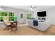Spacious living room with an office nook, sleek fireplace, white sofa, and bright windows at 309 Mcdaniel Pl, Canton, GA 30115