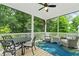 Inviting screened porch with comfortable seating, ceiling fan, and views of the lush surroundings at 309 Mcdaniel Pl, Canton, GA 30115