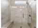 Sleek walk-in shower featuring contemporary tile work, glass enclosure, and built-in bench at 309 Mcdaniel Pl, Canton, GA 30115
