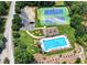 Aerial view of community pool and tennis courts; perfect for recreation and enjoying neighborhood amenities at 3885 Lake Juliette Dr, Buford, GA 30519